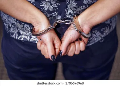 arrested-woman-handcuffed-hands-back-260nw-1706696968